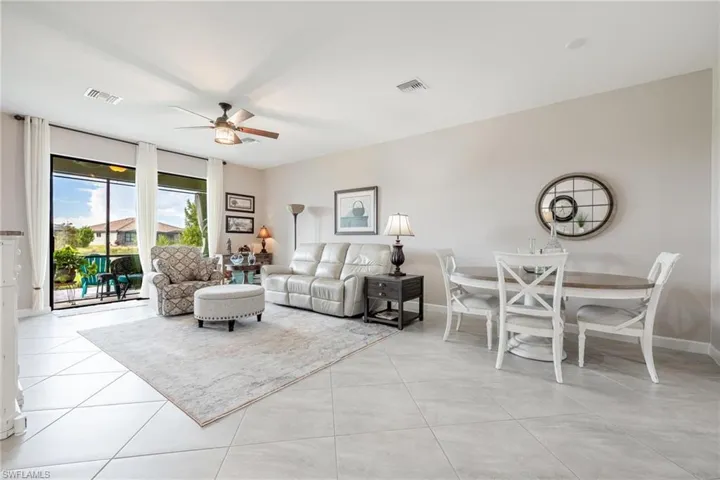 Tiled living room featuring ceiling fan