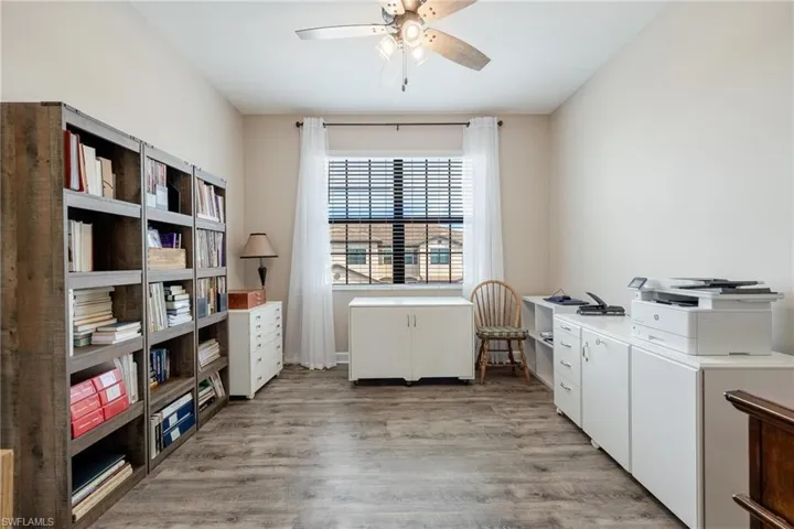 Laundry area with light hardwood / wood-style flooring, cabinets, and ceiling fan
