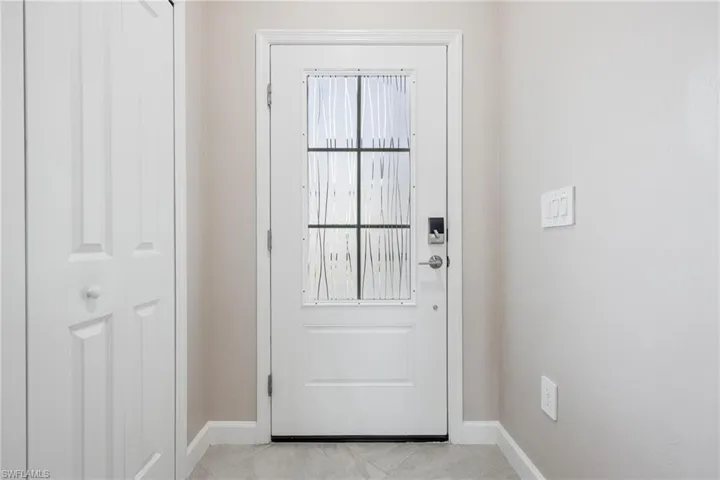 Doorway to outside with light tile patterned flooring