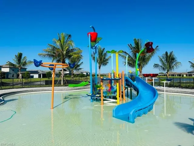 View of play area with a fenced in pool