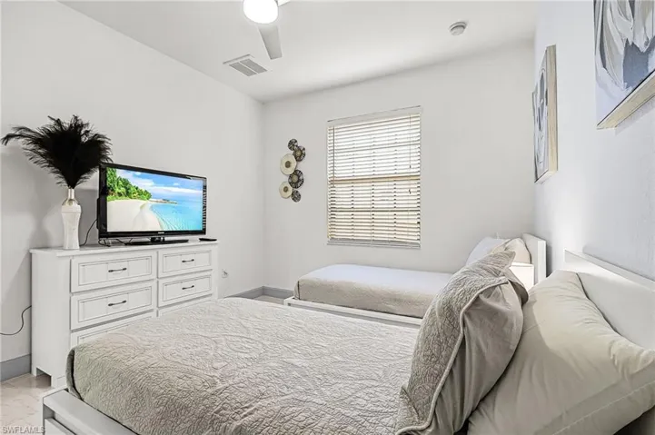 Bedroom featuring ceiling fan and baseboards