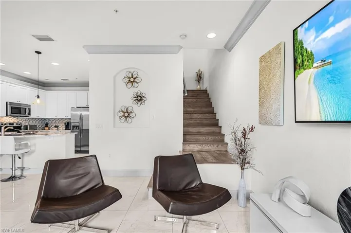 Sitting room with recessed lighting and stairway