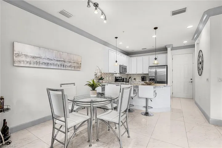 Dining space with light marble finish flooring and recessed lighting