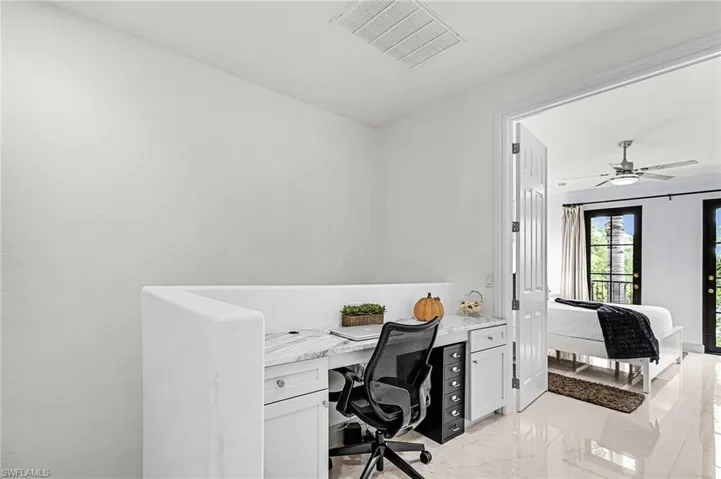 Office featuring light marble finish flooring and ceiling fan