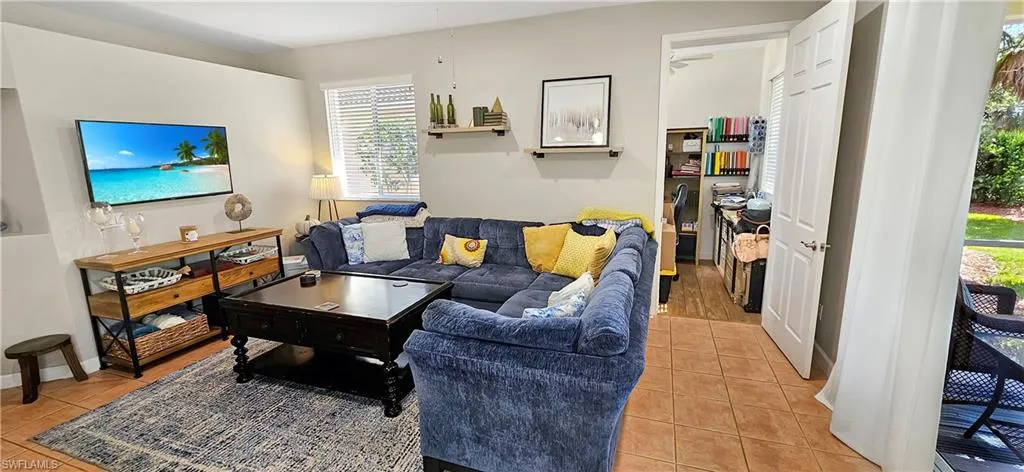 Living area with light tile patterned floors and baseboards