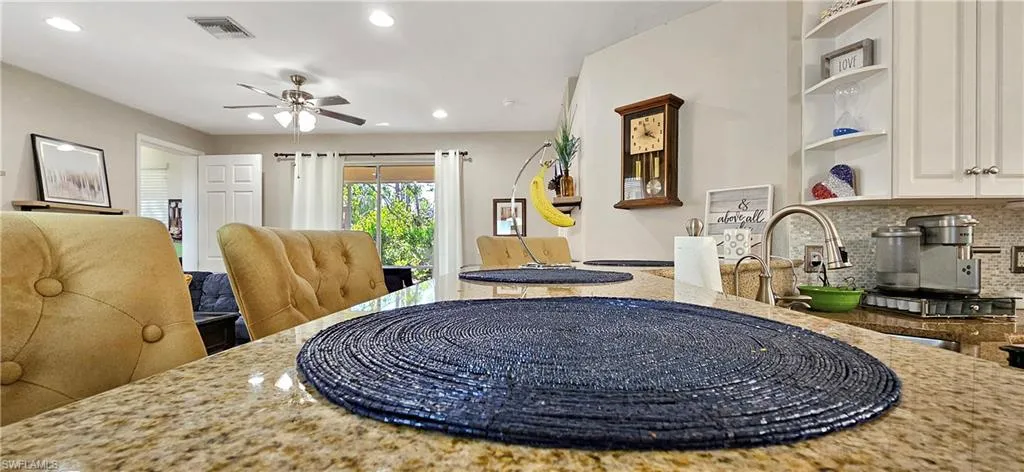 Dining room with a ceiling fan, visible vents, and recessed lighting