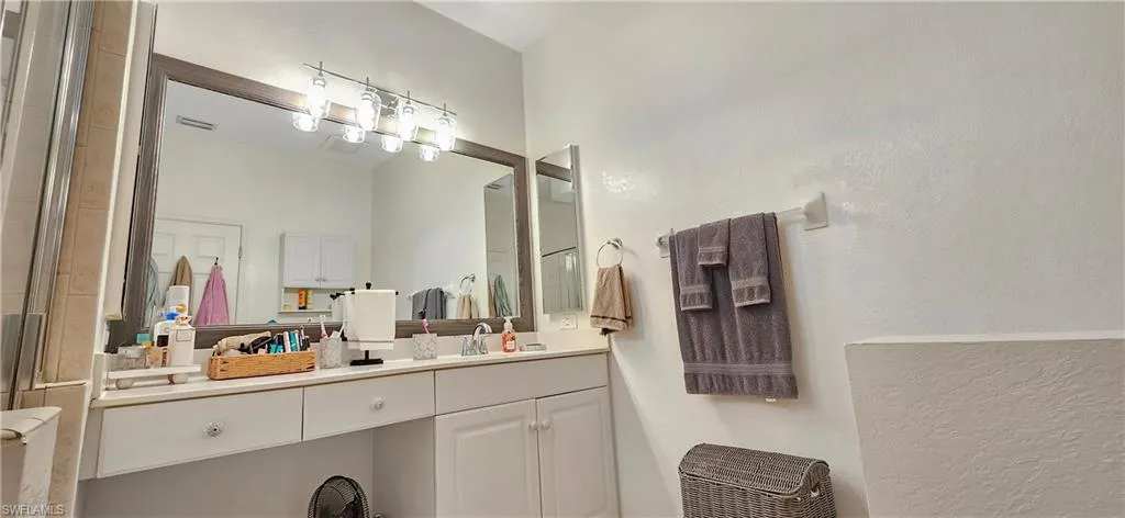 Full bathroom with vanity and a shower with door