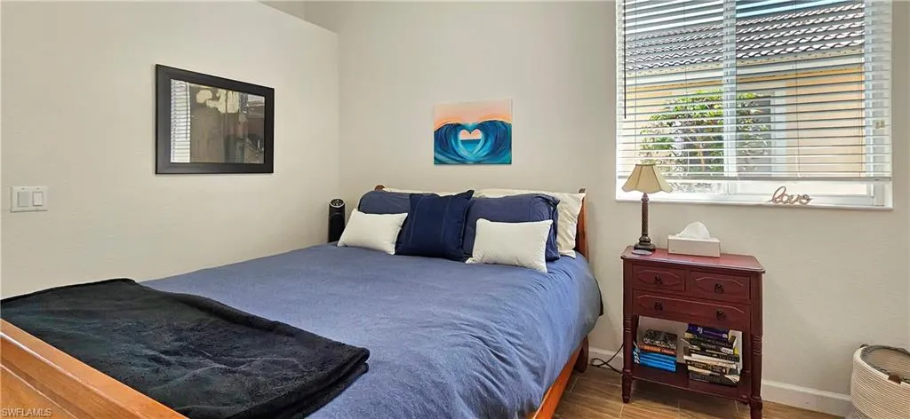 Bedroom with baseboards and wood finished floors