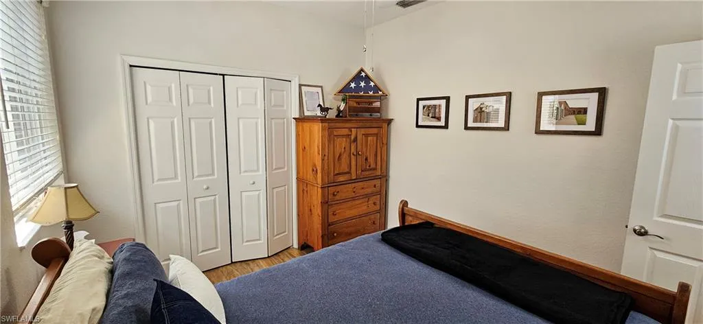 Bedroom featuring a closet and light wood-style flooring