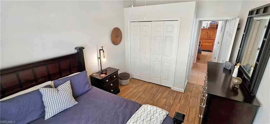 Bedroom with a closet and light wood-style flooring