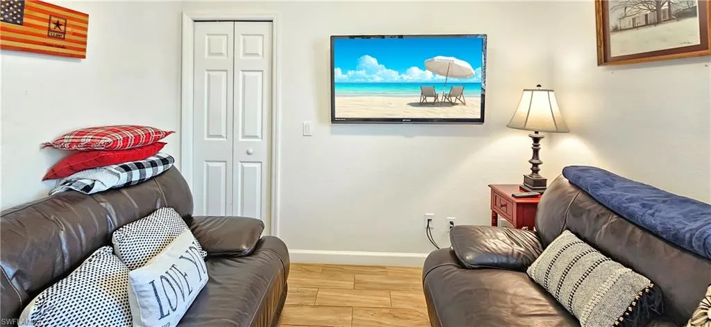 Living room featuring baseboards and wood finish floors