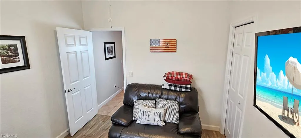 Sitting room with baseboards and wood finished floors