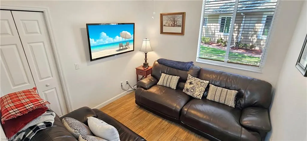 Living area with baseboards and wood finished floors