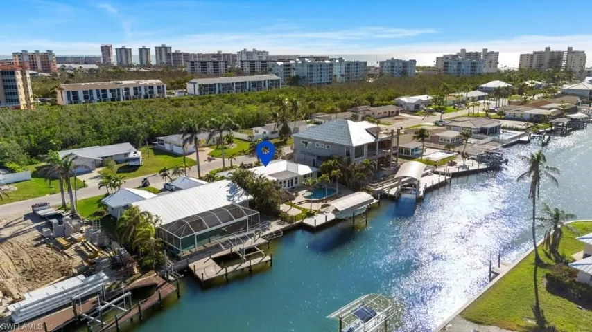 Aerial view featuring a view of city and a water view - VIRTUALLY ENHANCED