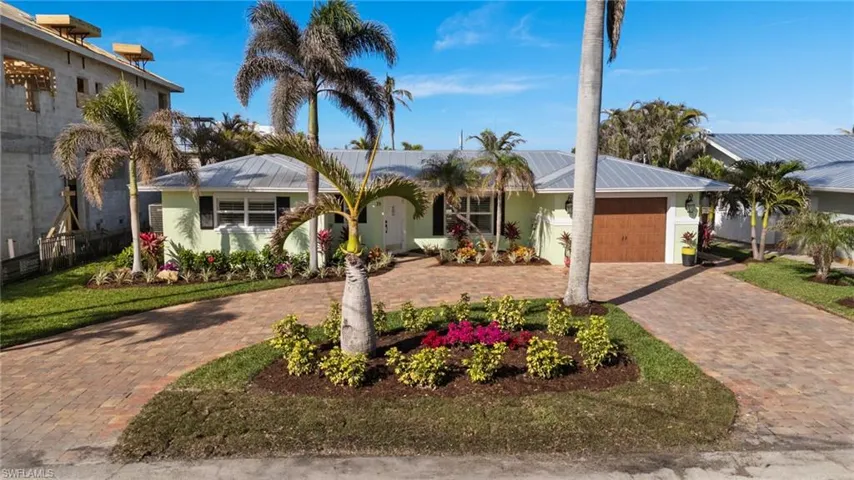 Ranch-style house with a garage and a front yard