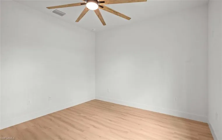 Unfurnished room featuring light wood-type flooring and ceiling fan