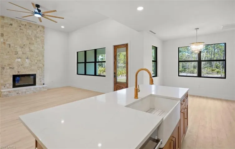 Kitchen with light wood-type flooring, healthy amount of natural light, decorative light fixtures, and recessed lighting
