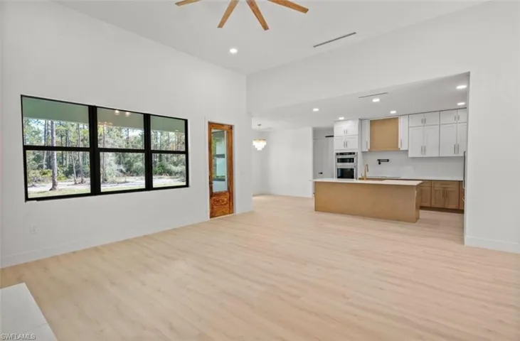 Unfurnished living room with light wood-type flooring, recessed lighting, and a ceiling fan