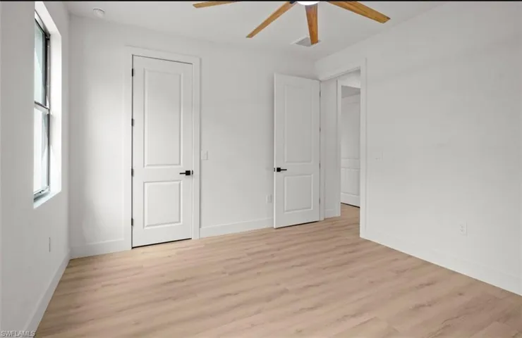 Unfurnished bedroom featuring light wood-type flooring and a ceiling fan