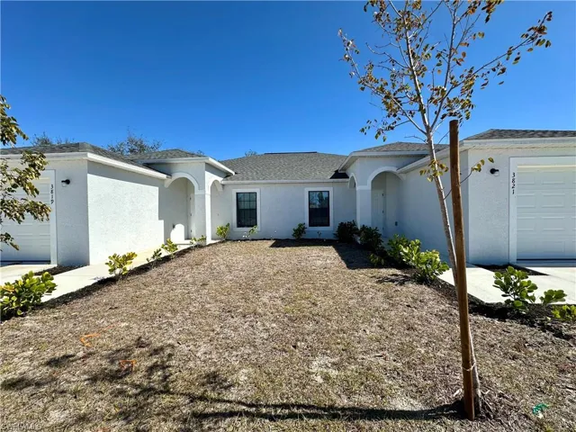 Ranch-style house with an attached garage, stucco siding, and a shingled roof