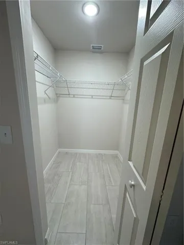 Walk in closet featuring light wood finished floors