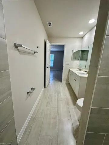 Full bath featuring double vanity and recessed lighting