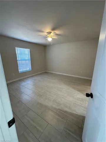 Empty room featuring wood tiled floors and ceiling fan