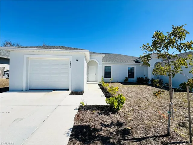 Ranch-style house featuring concrete driveway, stucco siding, a garage, and roof with shingles