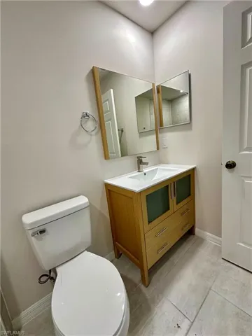 Half bath featuring vanity and toilet