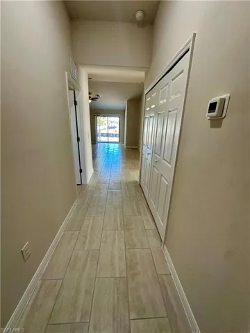 Hallway featuring baseboards and wood finish floors