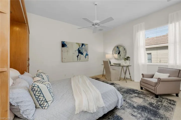 Bedroom with ceiling fan and carpet flooring