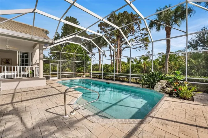 View of swimming pool featuring a lanai, ceiling fan, and a patio area