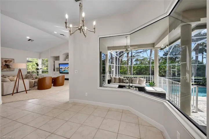 Unfurnished dining area with ceiling fan with notable chandelier
