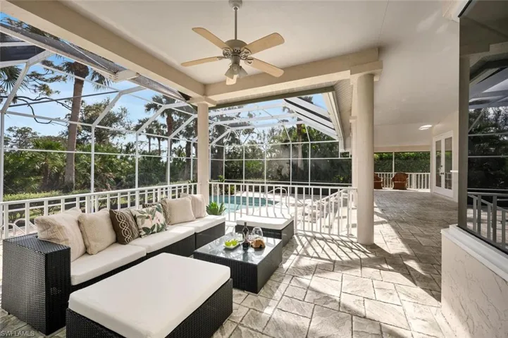 View of patio / terrace featuring a lanai, ceiling fan, and outdoor lounge area