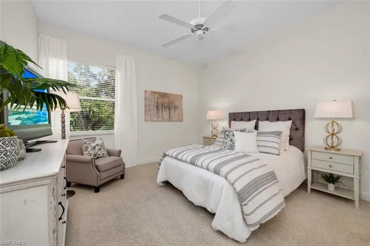 Bedroom featuring ceiling fan and light carpet