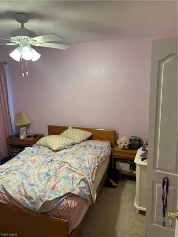 Bedroom featuring light carpet and a ceiling fan