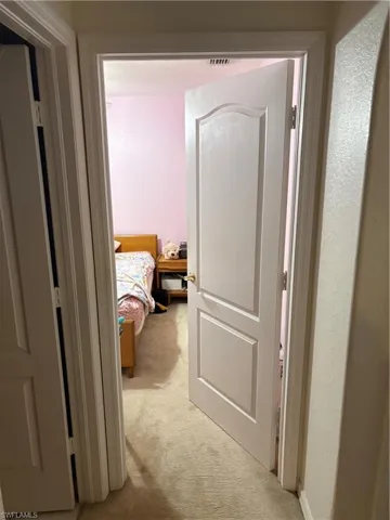 Hall with light colored carpet