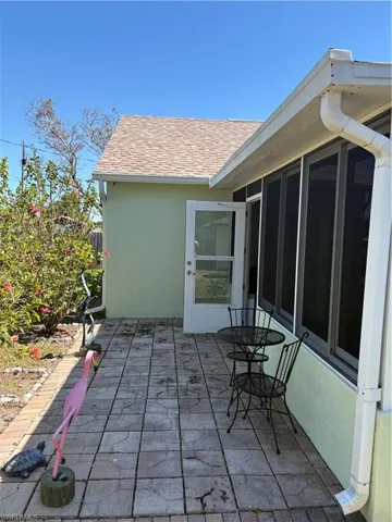 View of patio with a sunroom