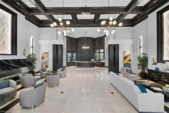 Grand entry with coffered ceilings, polished tile flooring, and sophisticated decorative lighting