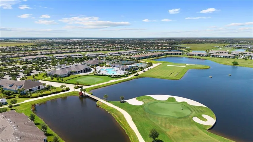 Expansive golf course community featuring multiple water features, golf greens, a large clubhouse, and multiple swimming pools
