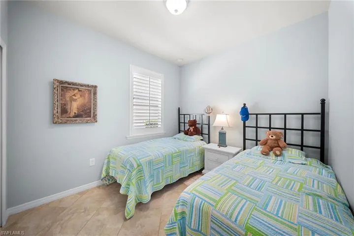 Light-toned flooring, white window trim, and a ceiling-mounted light fixture