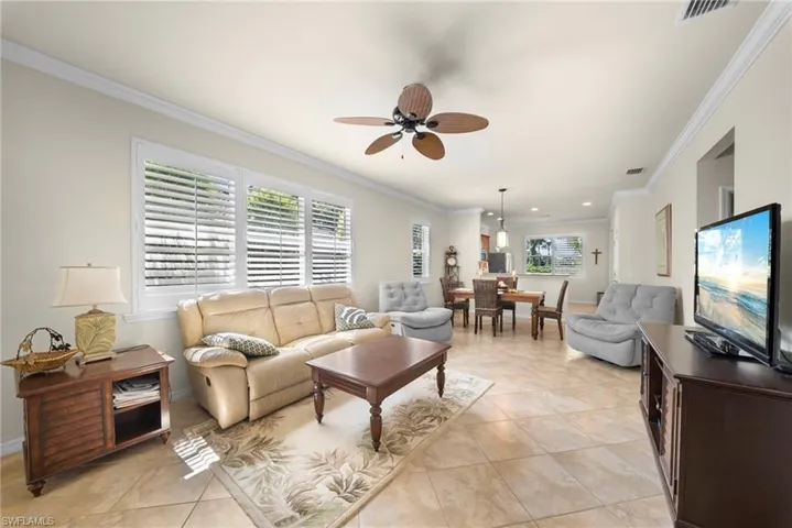 Recessed lighting, crown molding, and tile flooring