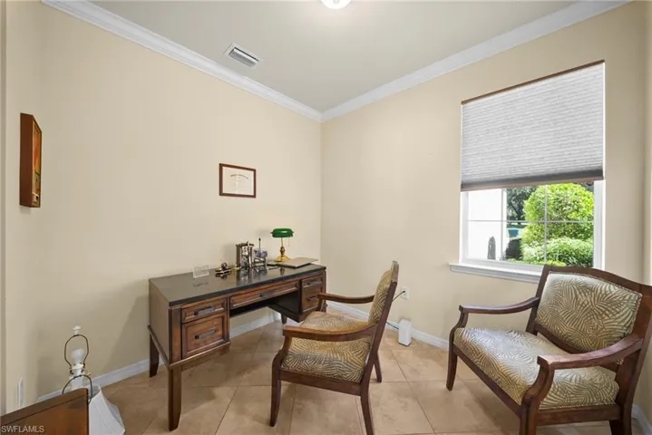 Recessed lighting with crown molding, single window with cellular shade, and tile flooring