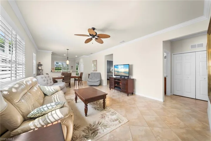 Plantation shutters, ceiling fan, crown molding, tile flooring, built-in bi-fold closet doors
