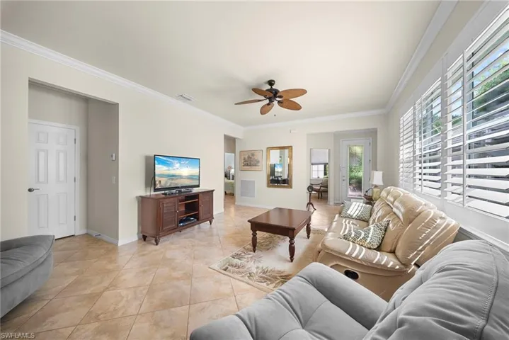 Crown molding and neutral wall paint complement the tile flooring