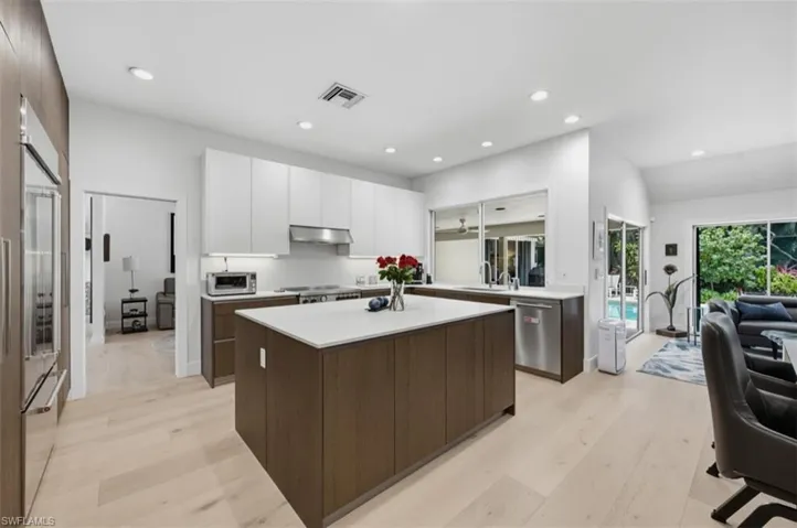 Custom cabinetry highlighted by quartz counters, premium gas range, & Sub-Zero refrigerator/freezer