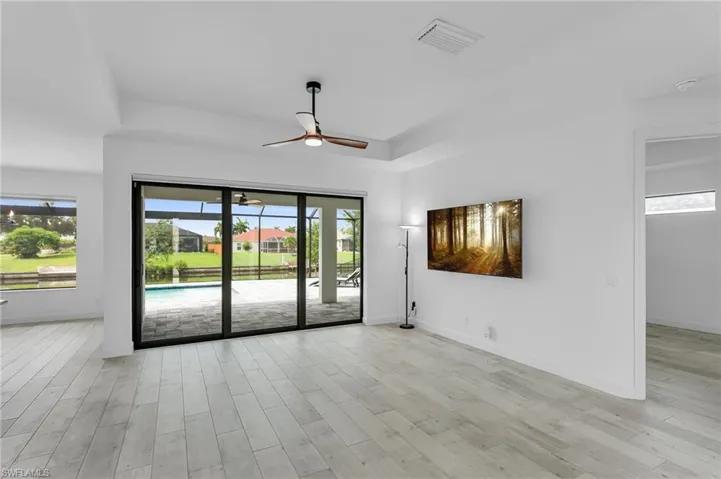 Unfurnished room with light hardwood / wood-style floors and ceiling fan