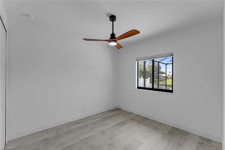 Spare room featuring light hardwood / wood-style floors and ceiling fan