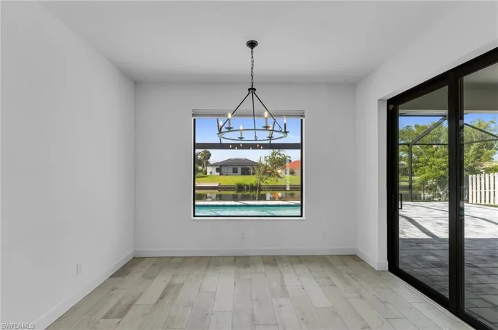 Unfurnished room featuring light hardwood / wood-style flooring and an inviting chandelier
