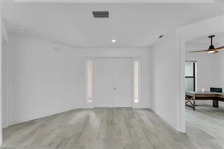 Entrance foyer with ceiling fan and light hardwood / wood-style floors